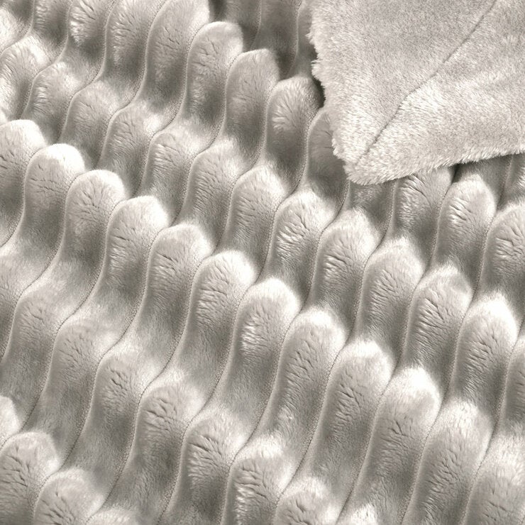 Zoomed in imagery of light grey ribbed throw, texured and soft Zoomed in imagery of light grey ribbed throw, texured and soft