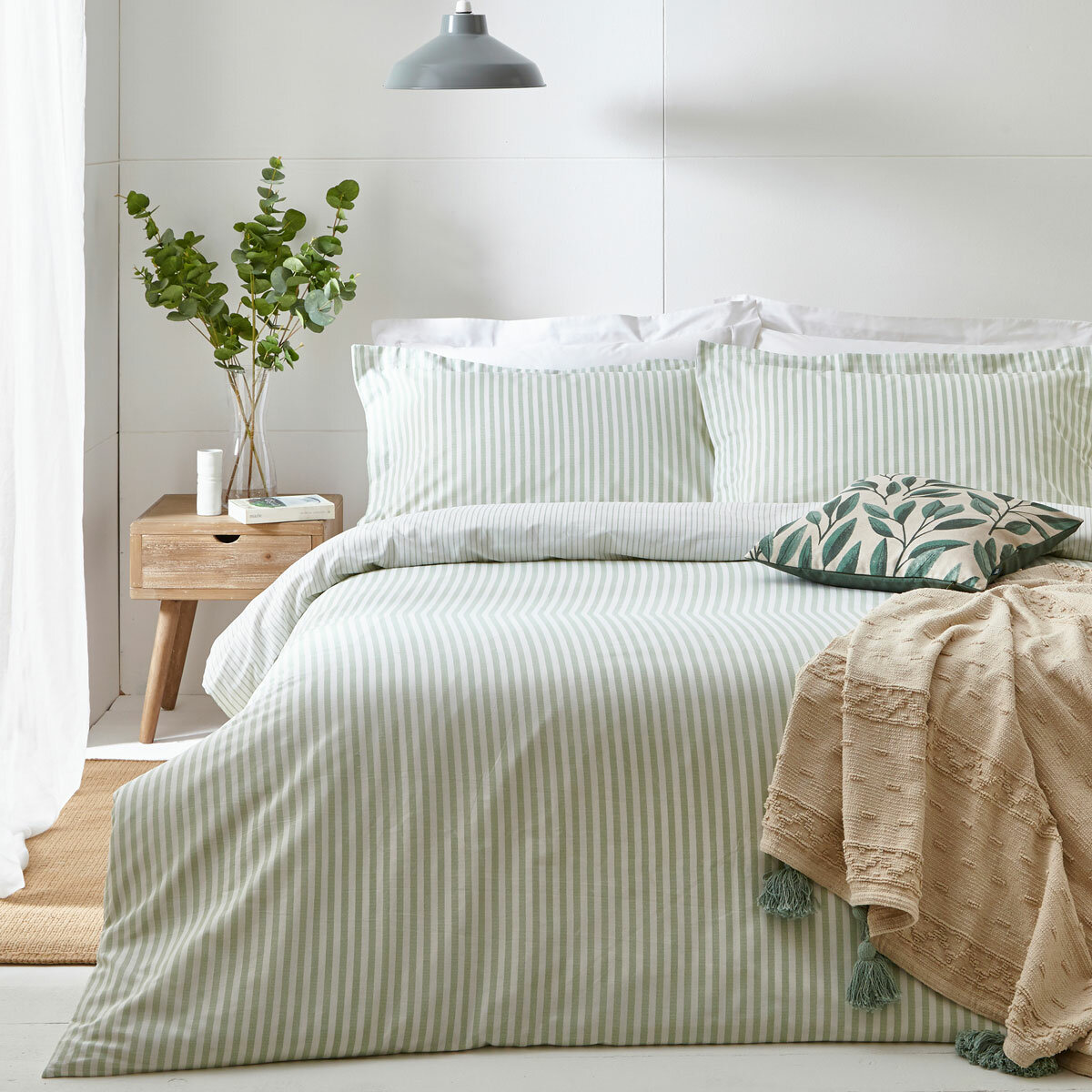 Light green and white vertically striped duvet set with matching pillowcases.