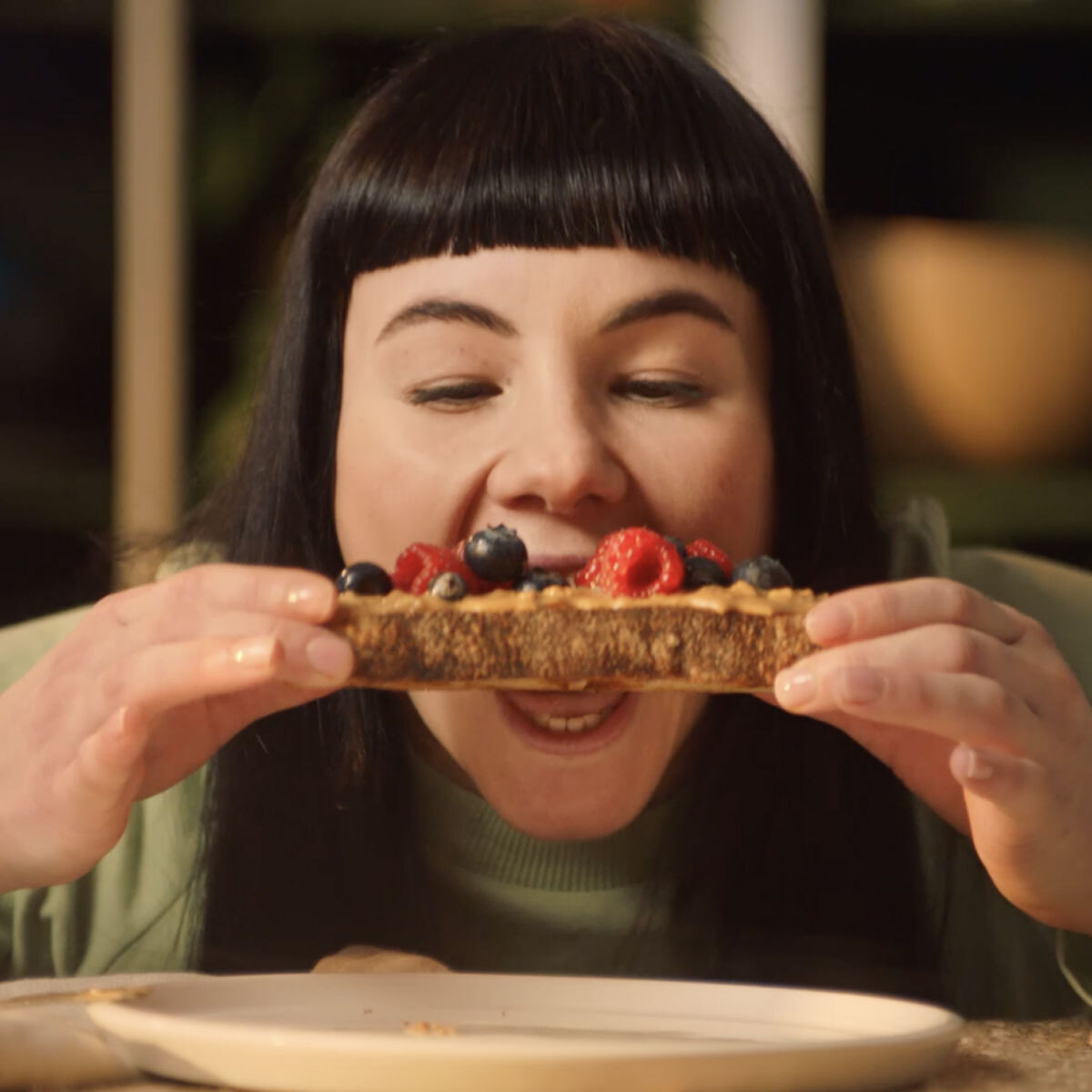 A Woman Eating Peanut Butter on Bread