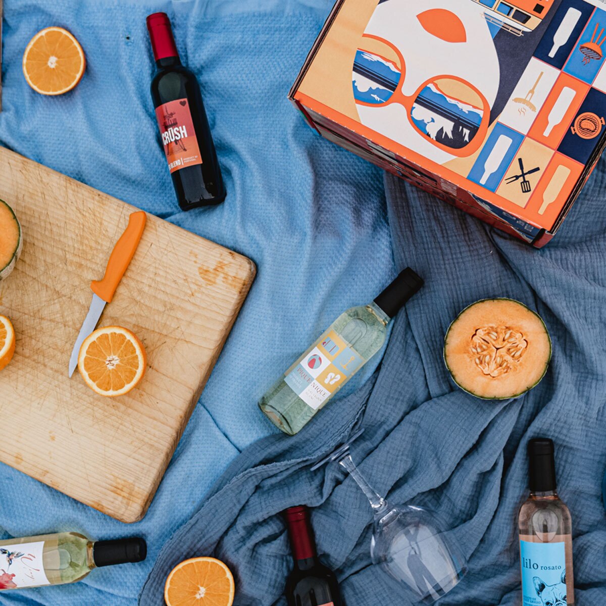 Lifestyle image of bottles out of box on blanket