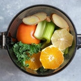 Lifestyle image of AUTO10S Juicer with smoothie ingredients inside