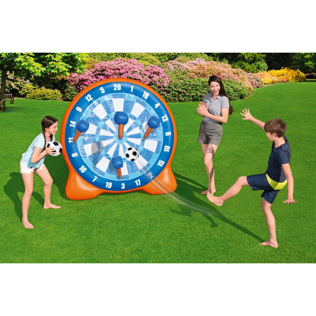 Lifestyle image of a woman and two children playing with the inflatable dartboard