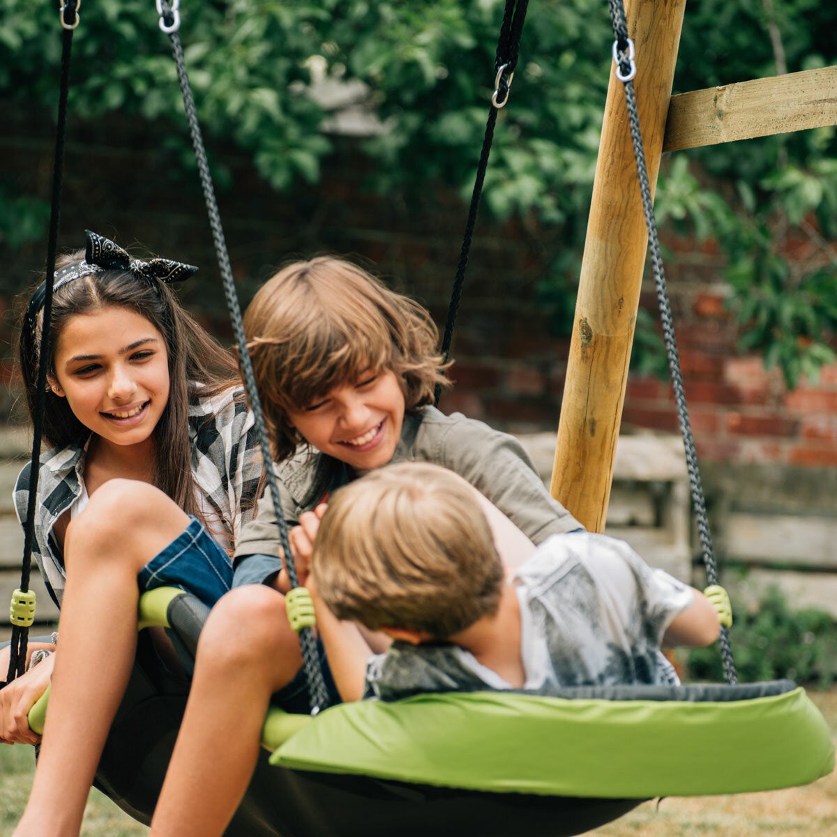 A lifestyle image of three children on the hammock swing A lifestyle image of three children on the hammock swing