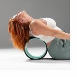 Lifestyle image of a woman using a wheel on her back