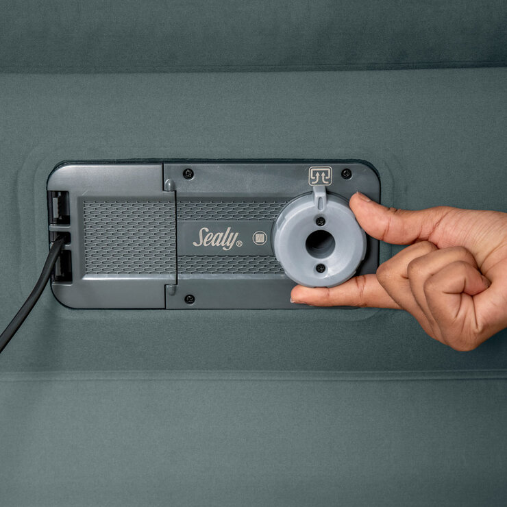 Lifestyle image of someone adjusting the air valve to deflate it