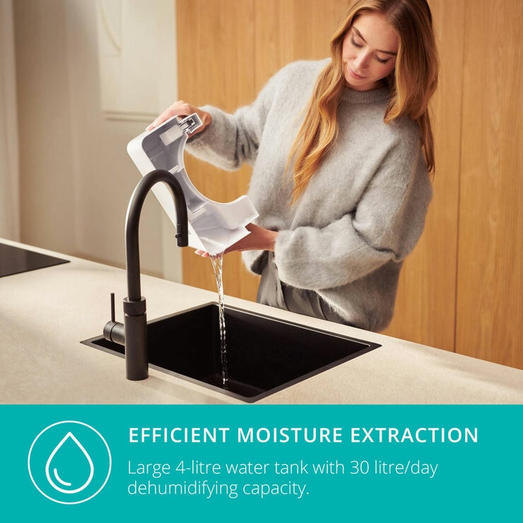 Lifestyle image of Bora Smart Dehumidifier 30L 's water tank being emptied