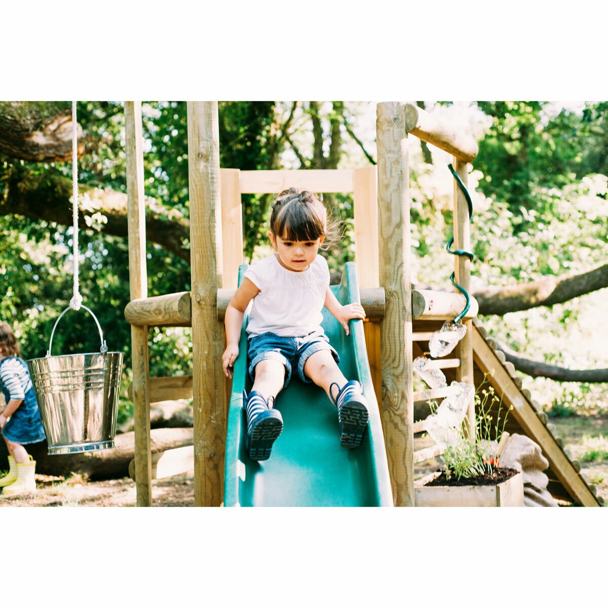 Lifestyle image of a child going down the slide Lifestyle image of a child going down the slide