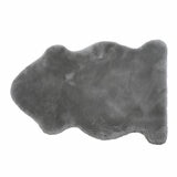 Grey lambskin-style rug with an irregular, cloud-like shape and soft, fluffy texture