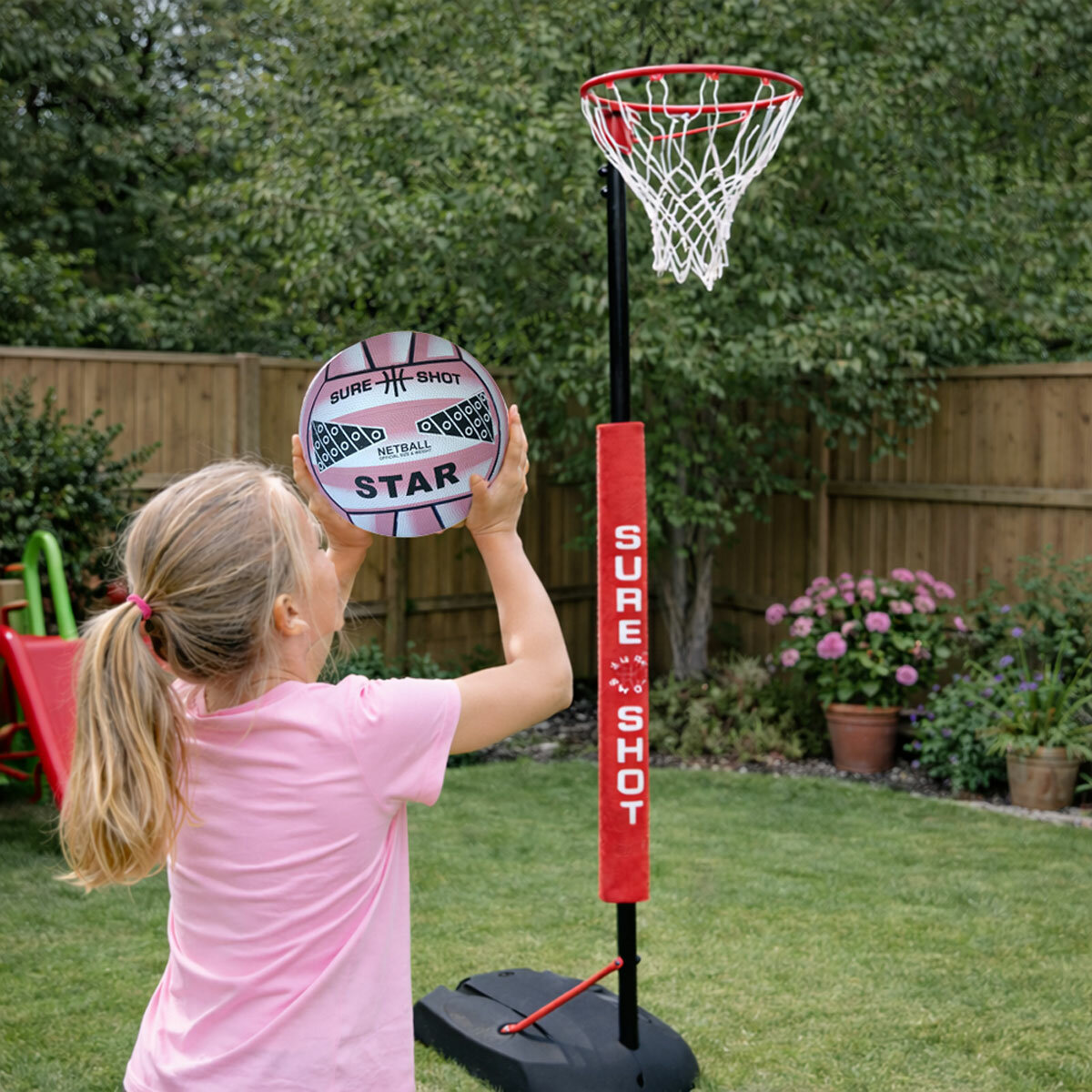 Lifestyle image of a girl throwing the netball at the unit