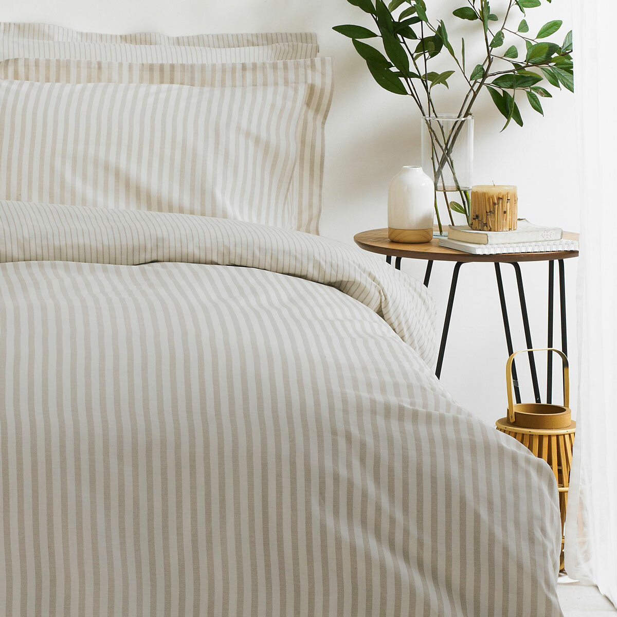Beige and white vertically striped duvet set with matching pillowcases.