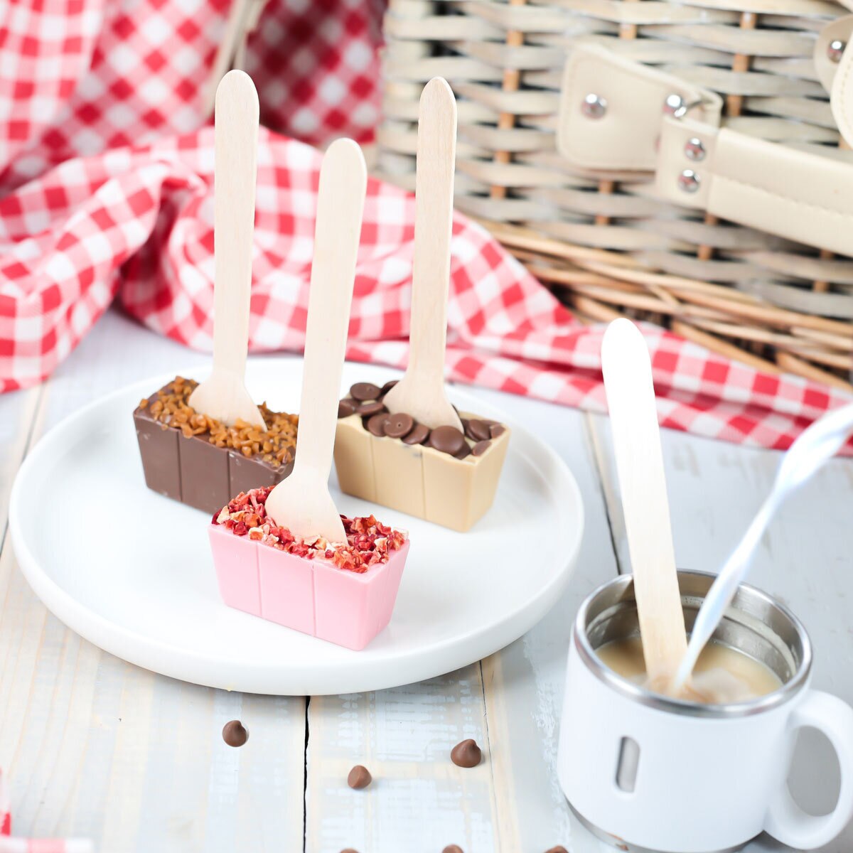 Hot chocolate spoons on plate and in mug with milk