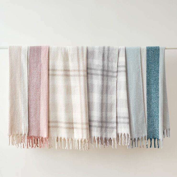Beige,Pink, Blue and Grey throws hung up together