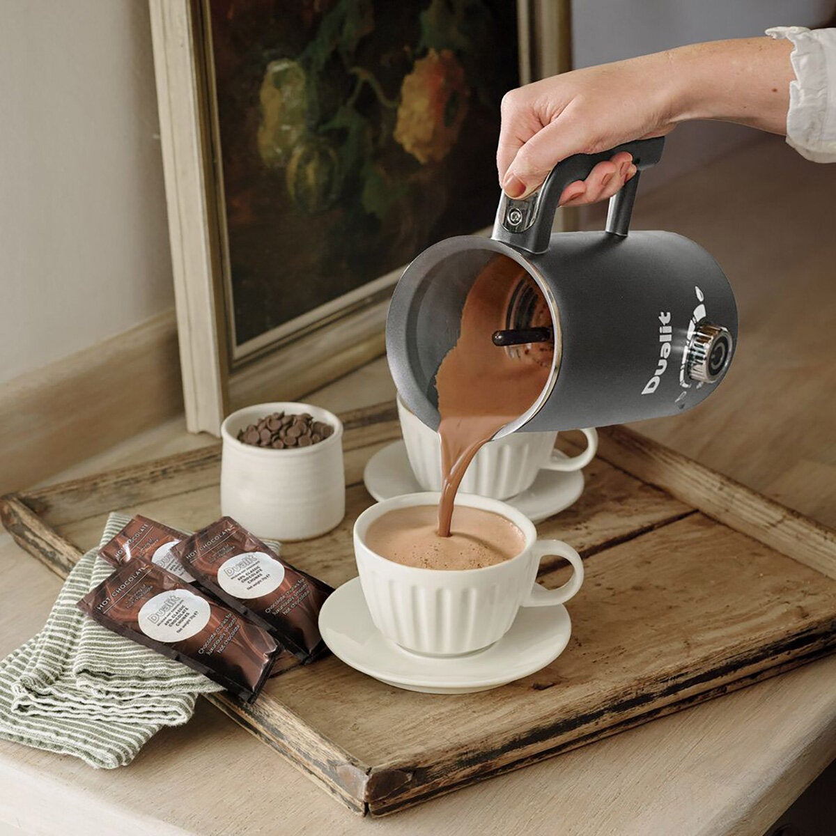 Life style image of hot chocolate being poured into a cup Life style image of hot chocolate being poured into a cup