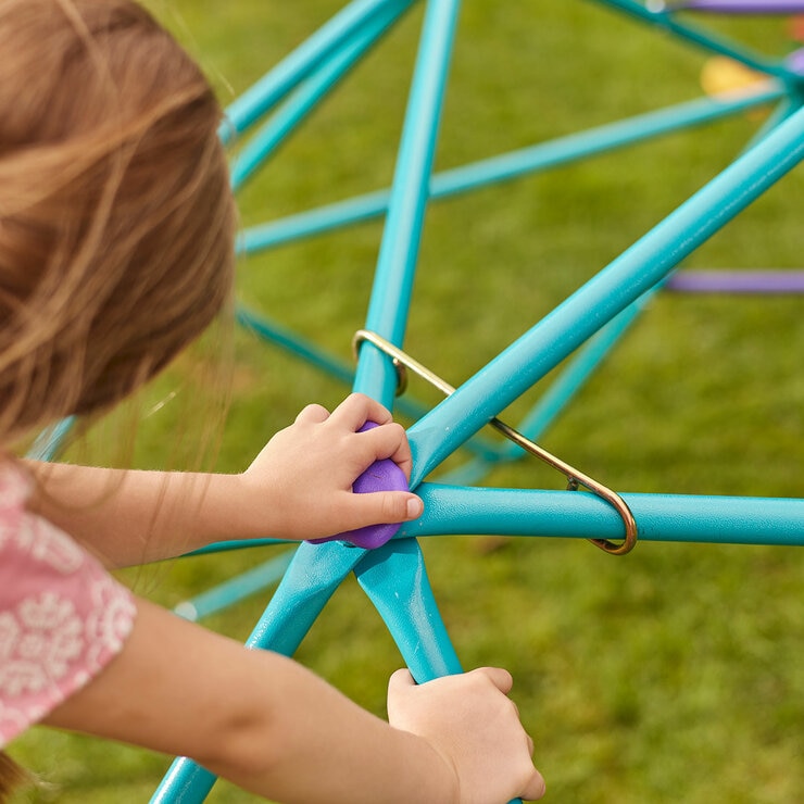 Lifestyle image showing a child climbing the dome