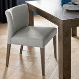 Lifestyle image of Milan lowback upholstered grey dining chair