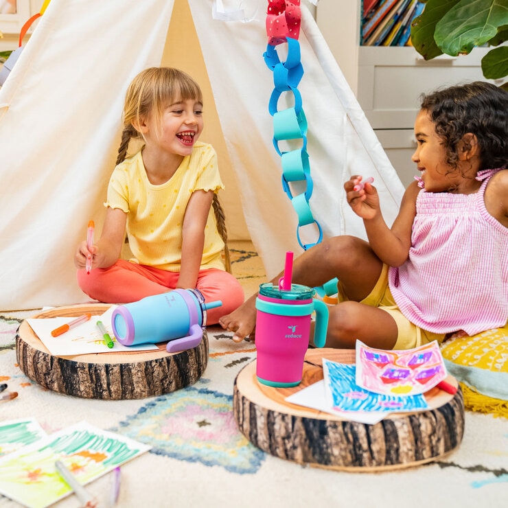 Two young girls playing outside with their Coldee bottles