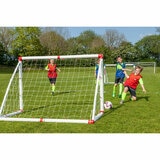Lifestyle image of children playing football, one of them is scoring a goal