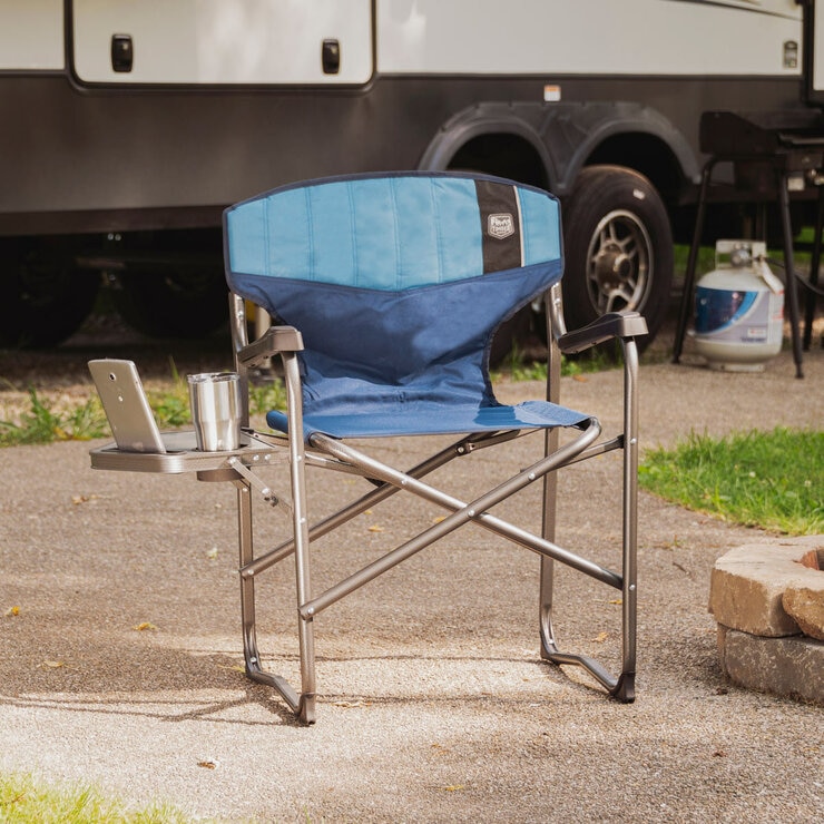 Lifestyle image of the Director's Chair with a bottle and device on the side table