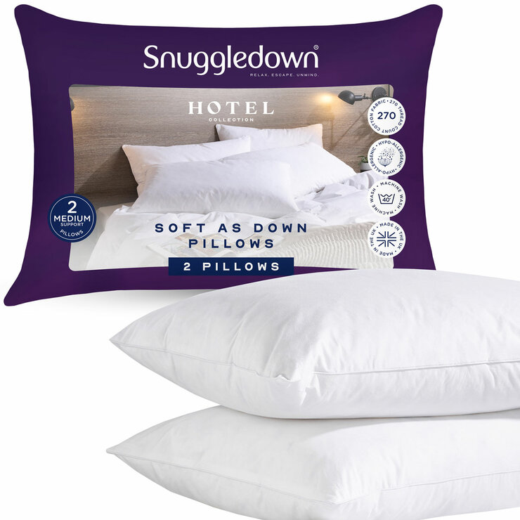Pack of two white pillows next to purple packaging