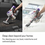 Lifestyle image of Dyson Car+Boat Handheld Vacuum showing being used outside of homes such as car, boat, motorhome