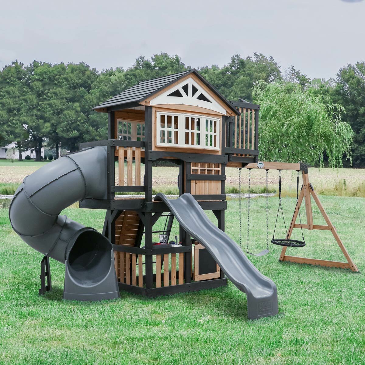 Lifestyle image of the Backyard Discovery Magnolia Falls Wooden Climbing Frame and Swing Set Lifestyle image of the Backyard Discovery Magnolia Falls Wooden Climbing Frame and Swing Set
