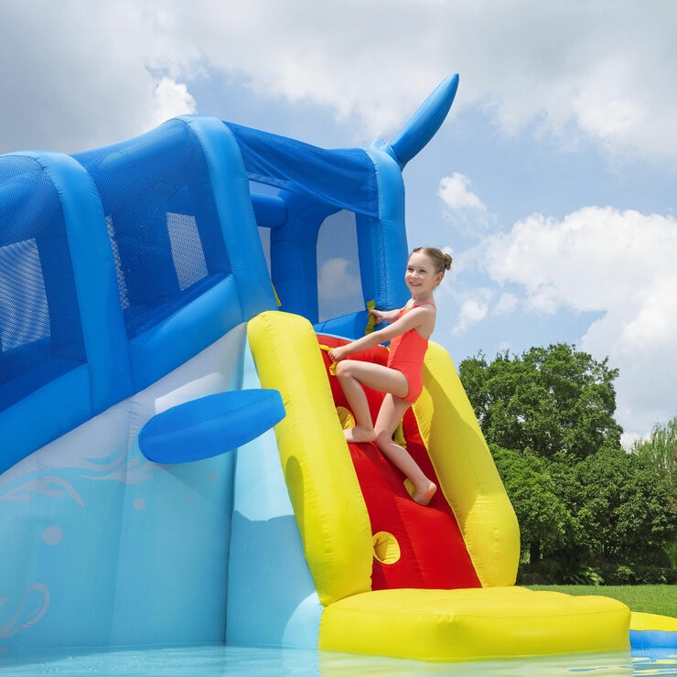 Lifestyle image of a child scaling the climbing wall