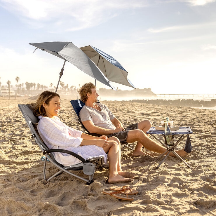 Lifestyle image of two people sat in the beach chairs