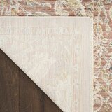 Pink and beige patterned rug with vintage-style floral and geometric motifs Pink and beige patterned rug with vintage-style floral and geometric motifs