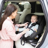 Lifestyle image of a mother putting child into the car