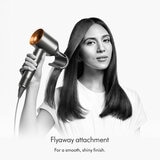 Lifestyle image of a model using Dyson Supersonic Hair Dryer using flyaway attachment