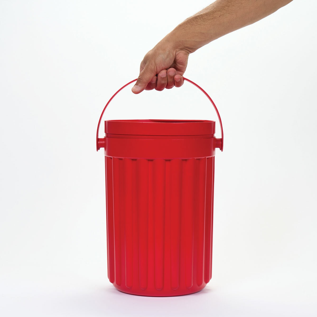 Studio image showing someone holding the bucket handle up