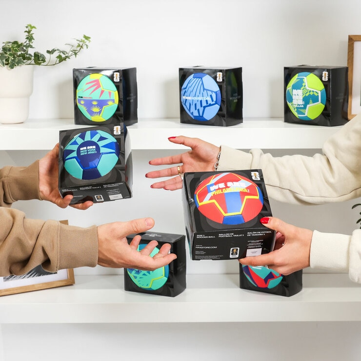 Lifestyle image of two people trading footballs