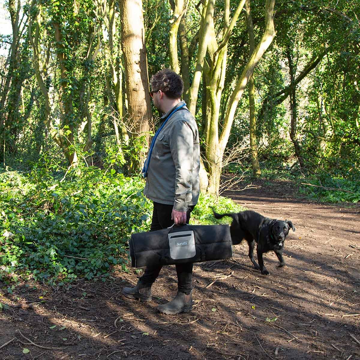 Man Carrying Travel Bed
