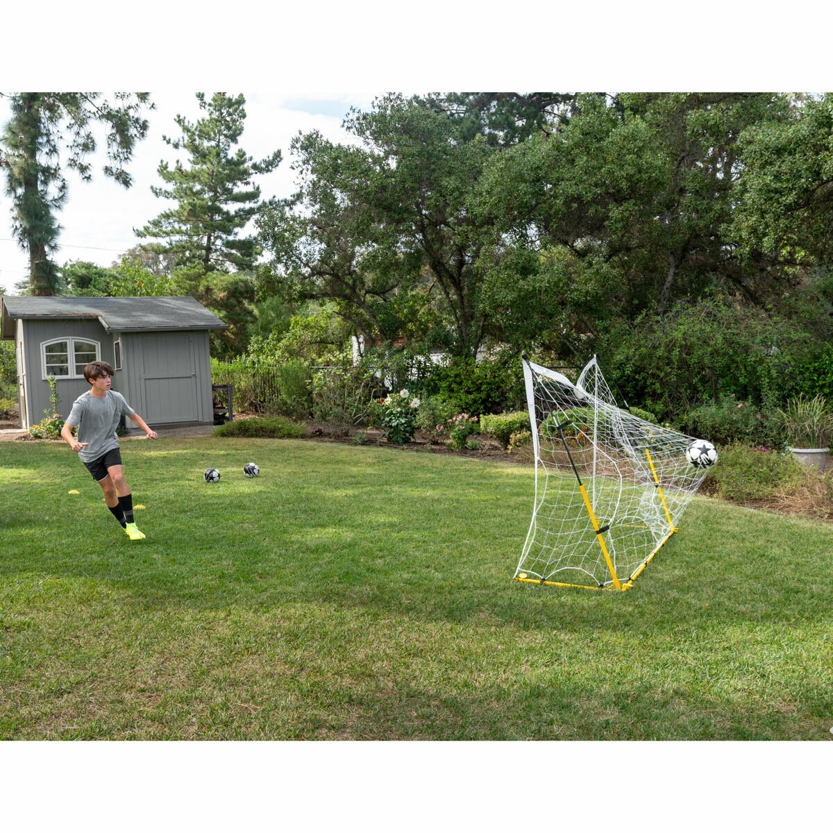 Lifestyle image of someone kicking a ball into the goal Lifestyle image of someone kicking a ball into the goal