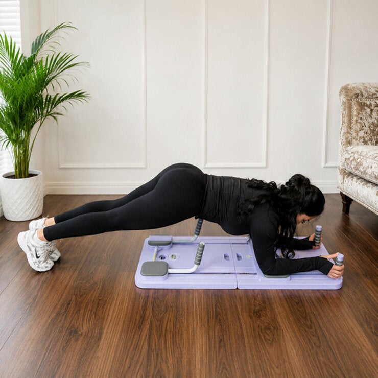 Lifestyle image of a woman using the Pilates Reformer