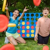 Lifestyle image of two children throwing the game pieces at the camera