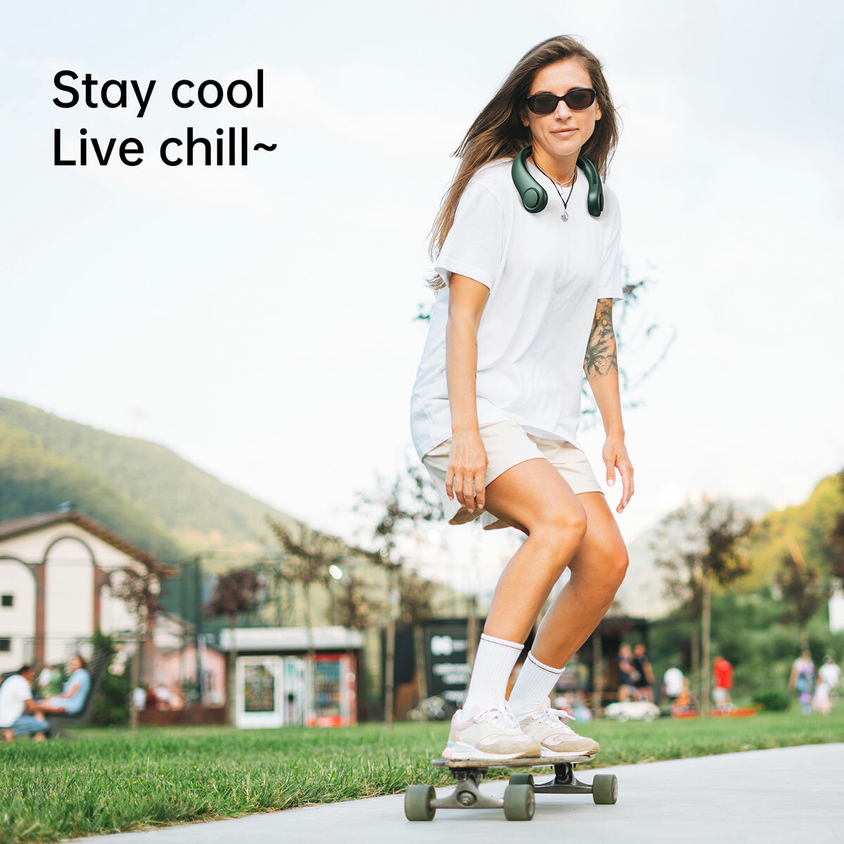 Lifestyle image of model wearing the neck fan whilst skate boarding Lifestyle image of model wearing the neck fan whilst skate boarding