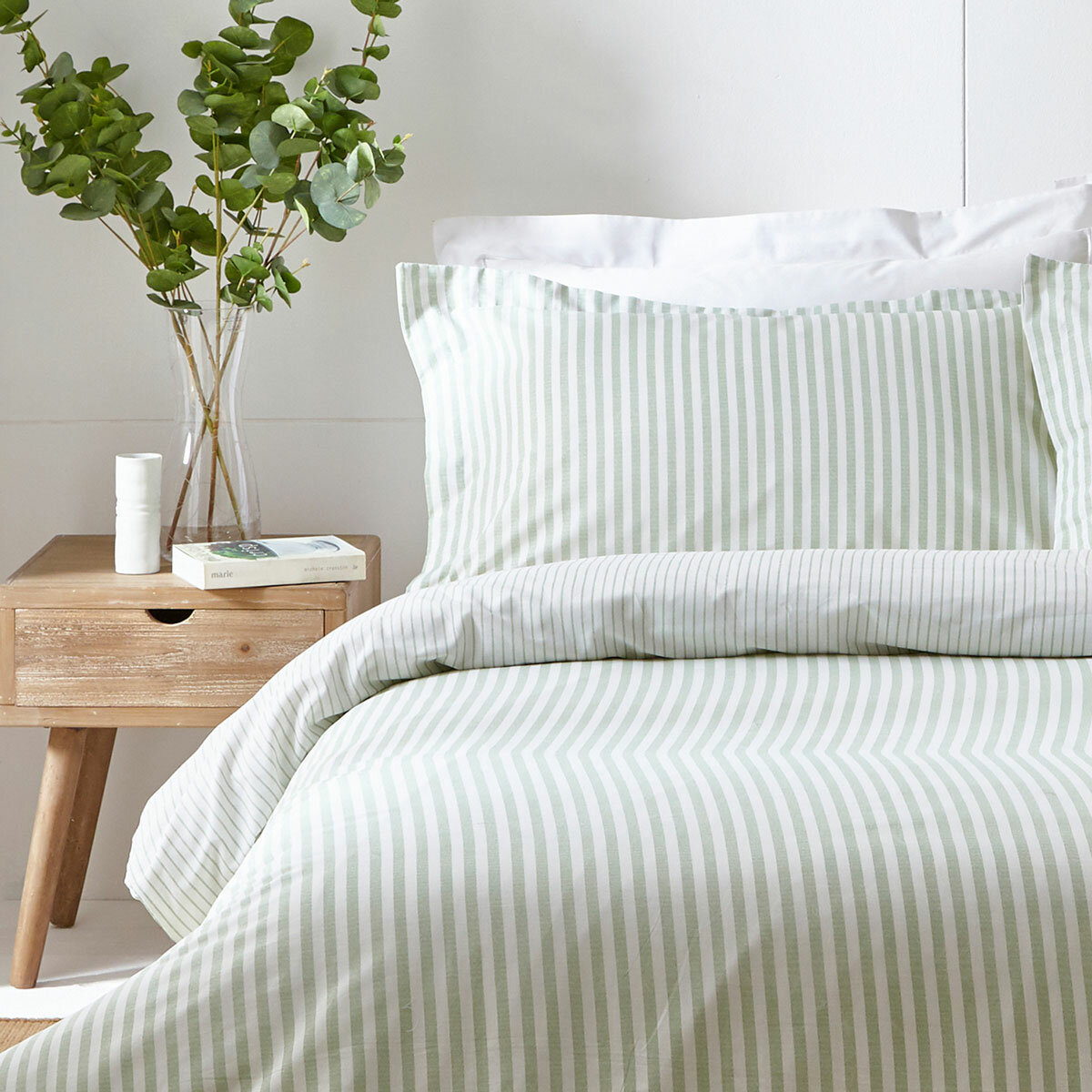 Light green and white vertically striped duvet set with matching pillowcases.