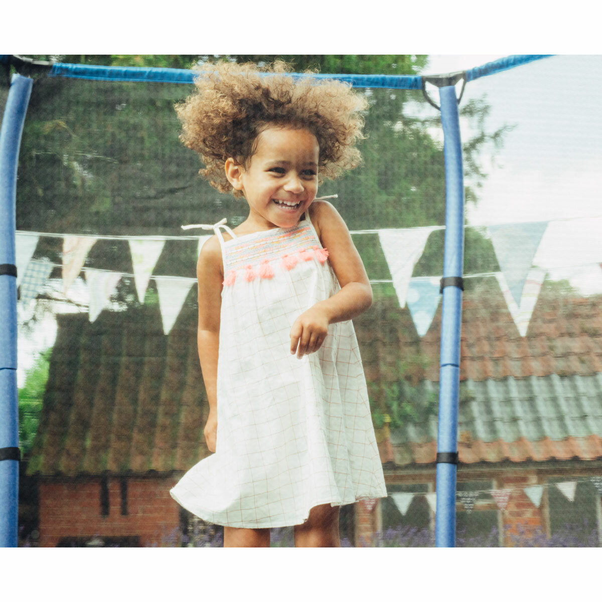 Lifestyle image of a child jumping on the trampoline