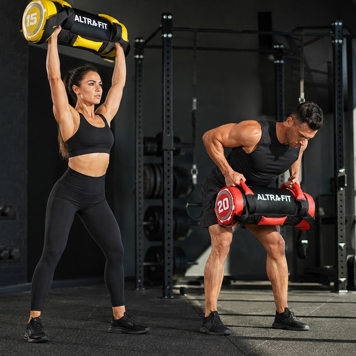Lifestyle image of a man and woman training with the power bags Lifestyle image of a man and woman training with the power bags