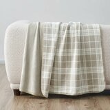 Taupe plaid throw staged on white sofa in a lifestyle image Taupe plaid throw staged on white sofa in a lifestyle image