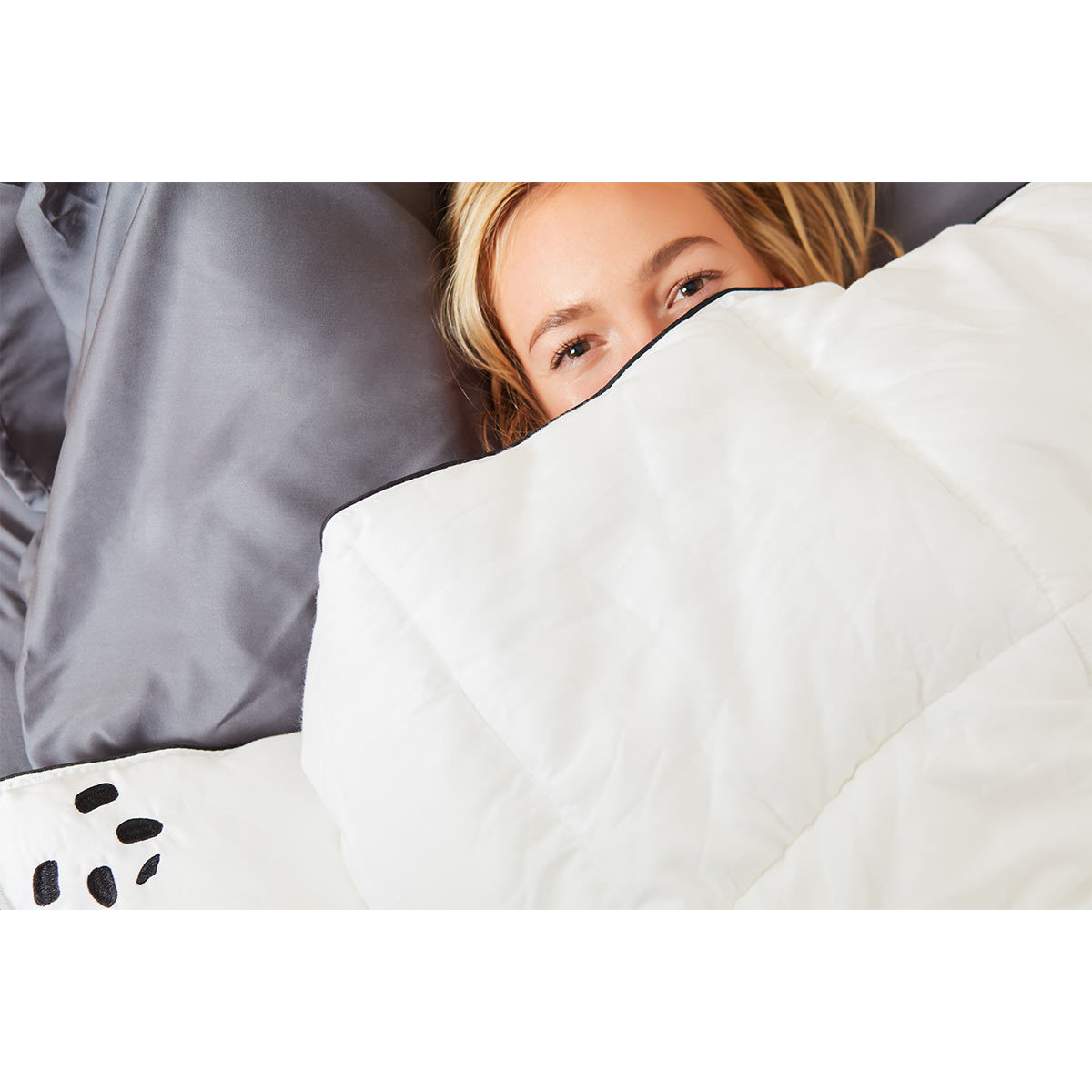 Duvet covering woman only eyes and top of head showing