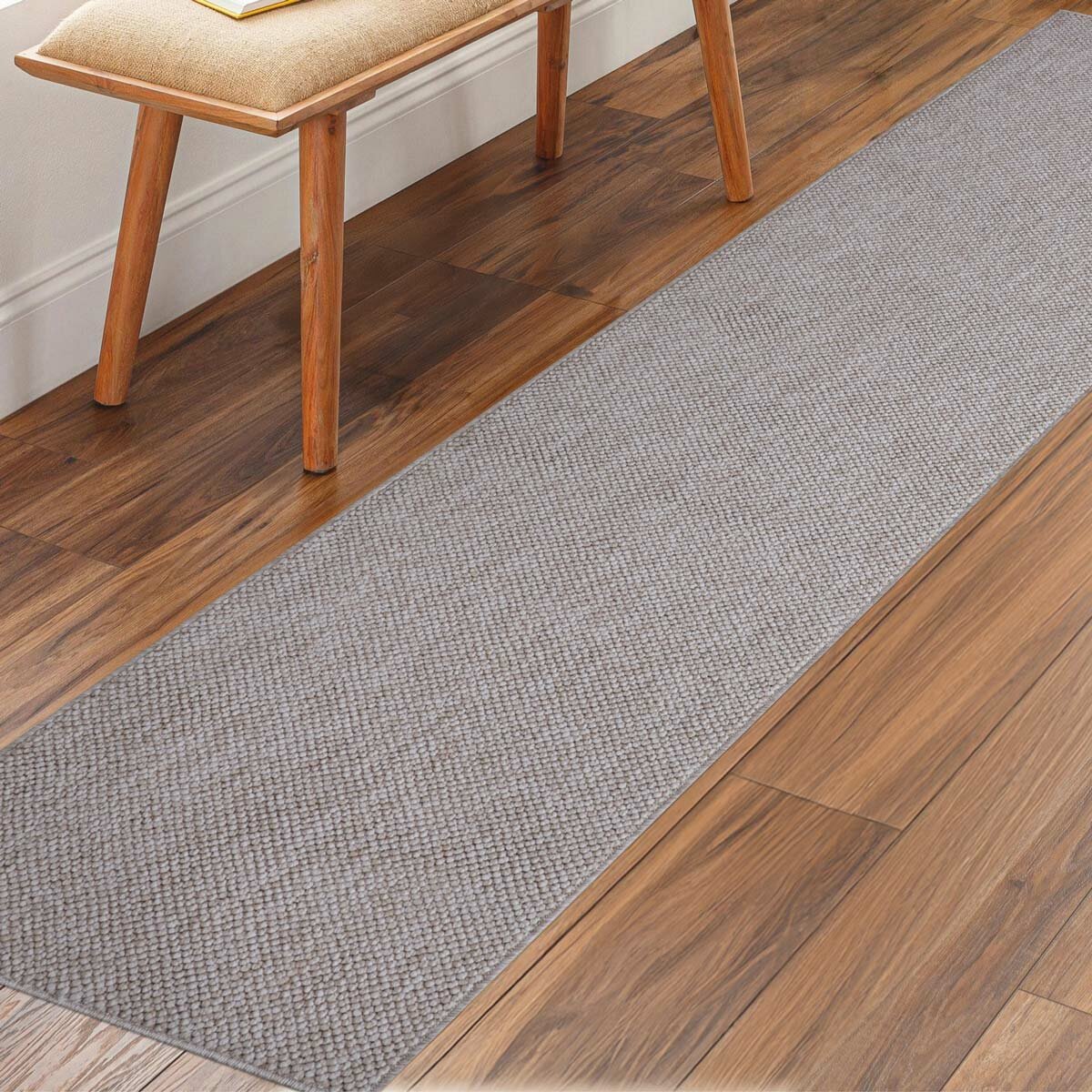 runner rug with a textured surface placed on a wooden floor