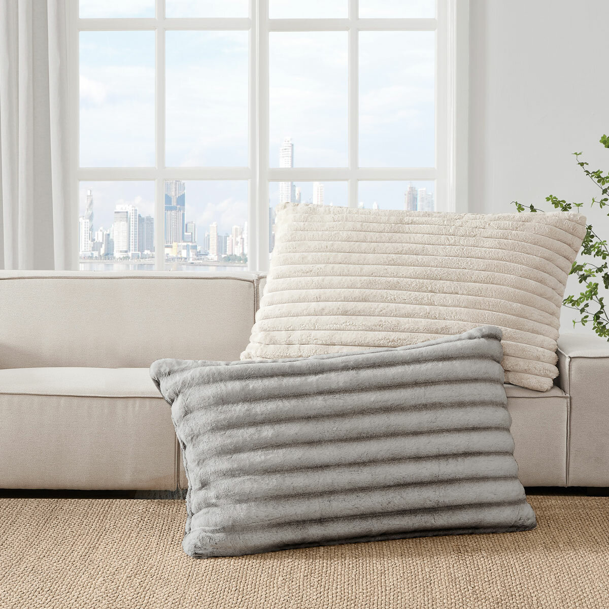 XL ribbed pillows with a plush texture resting on a beige sofa