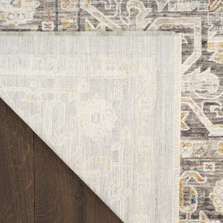 Beige and grey rug with central medallion and ornate symmetrical pattern