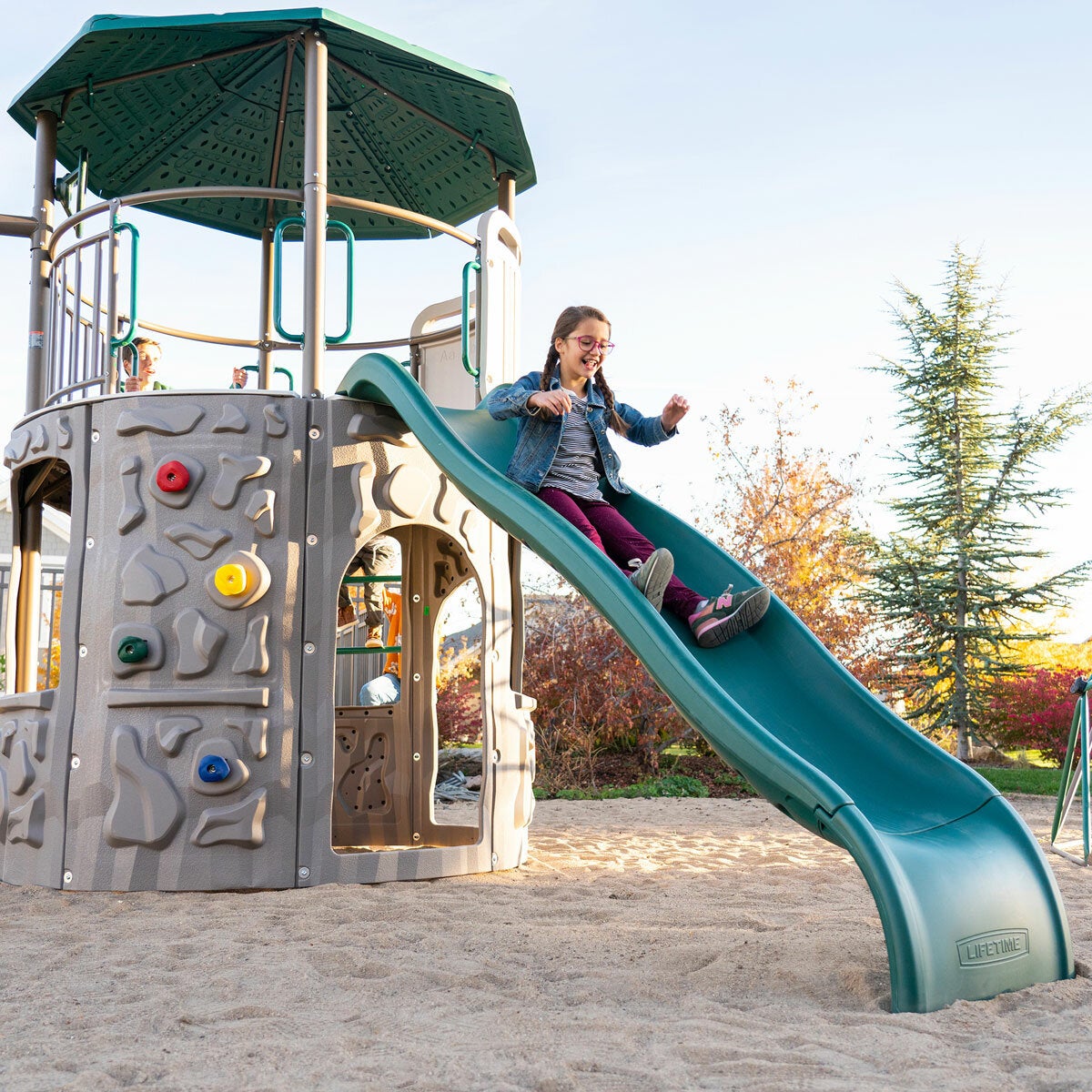 Lifestyle image of a child going down the slide Lifestyle image of a child going down the slide