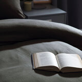 image of bed with charcoal snug bundle set with a open book on the duvet
