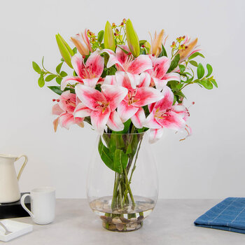 Artificial Pink Lilies and Mixed Foliage in Glass Vase