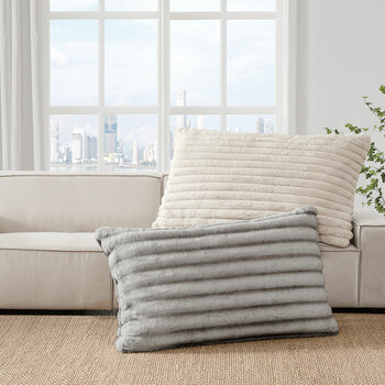 XL ribbed pillows with a plush texture resting on a beige sofa
