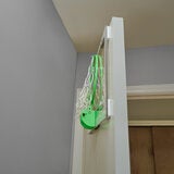 Lifestyle image showing the hoop laying flat against a door Lifestyle image showing the hoop laying flat against a door